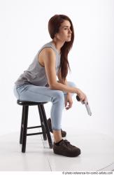Woman Adult Athletic White Fighting with gun Sitting poses Casual